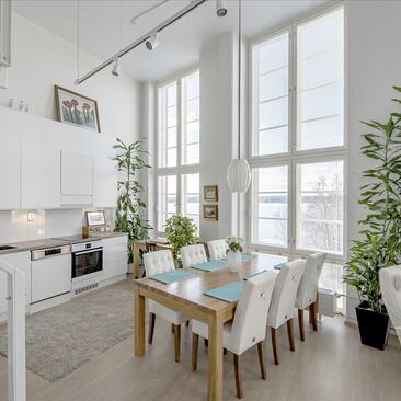 Loft-asunnon valkoinen, korkea ja valoisa keittiö